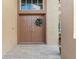 Front entrance with double doors and decorative wreath, tiled walkway, and tan exterior at 13003 Carlington Ln, Riverview, FL 33579