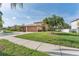 Attractive home with a three-car garage, basketball hoop, and palm trees at 13003 Carlington Ln, Riverview, FL 33579