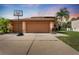 Home with three-car garage, basketball hoop, landscaped front yard and a beautiful sky at 13003 Carlington Ln, Riverview, FL 33579