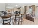 Open-concept kitchen boasts a breakfast bar, stainless steel appliances, and a view of the living area at 13003 Carlington Ln, Riverview, FL 33579