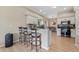 Kitchen features stylish breakfast bar seating, white cabinets, modern appliances and light, bright flooring at 13003 Carlington Ln, Riverview, FL 33579