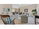 Open-concept living room with neutral decor, modern furnishings, and access to the dining area at 13003 Carlington Ln, Riverview, FL 33579
