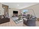 Inviting living room with neutral color scheme, modern furnishings, and ample natural light at 13003 Carlington Ln, Riverview, FL 33579