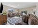 Comfortable living room with contemporary furnishings, and sliding glass doors to the outdoor living area at 13003 Carlington Ln, Riverview, FL 33579