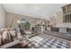 Open living area flows to the kitchen with breakfast bar and features access to the outdoor living space at 13003 Carlington Ln, Riverview, FL 33579