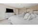Relaxing main bedroom showcasing a beautifully made bed, and elegant neutral-toned furnishings at 13003 Carlington Ln, Riverview, FL 33579