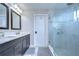 Sleek bathroom featuring double sinks with marble countertops and a modern glass-enclosed shower at 13118 Payton St, Odessa, FL 33556