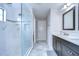 Modern bathroom featuring a glass shower, dark cabinets, marble countertops, and tile flooring at 13118 Payton St, Odessa, FL 33556