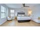 Bright, modern bedroom showcasing wood floors, multiple windows and stylish contemporary furniture at 13118 Payton St, Odessa, FL 33556