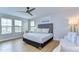 Bright, modern bedroom showcasing wood floors, multiple windows and stylish contemporary furniture at 13118 Payton St, Odessa, FL 33556