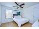 Inviting bedroom with modern decor, wood floors, and a wave art piece over the bed at 13118 Payton St, Odessa, FL 33556