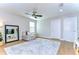 Spacious bedroom with modern ceiling fan, cushioned bench, and large mirror on display at 13118 Payton St, Odessa, FL 33556