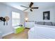 Comfortable bedroom with modern decor, stylish dresser, and an abstract art piece on the wall at 13118 Payton St, Odessa, FL 33556