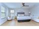 Bright bedroom with natural light, fan, stylish decor, and cozy seating area, a perfect retreat at 13118 Payton St, Odessa, FL 33556