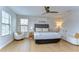 Bright bedroom with natural light, fan, stylish decor, and cozy seating area, a perfect retreat at 13118 Payton St, Odessa, FL 33556