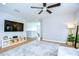 Spacious bonus room with TV, ceiling fan and views of second floor hallway and staircase at 13118 Payton St, Odessa, FL 33556