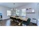Dining room with a wooden table, black chairs, and natural light from the windows at 13118 Payton St, Odessa, FL 33556