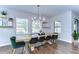 Bright dining room featuring a rustic wood table, modern chandelier, and stylish decor at 13118 Payton St, Odessa, FL 33556