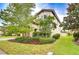 Attractive house exterior with a landscaped front yard, mature trees, and a well-maintained lawn at 13118 Payton St, Odessa, FL 33556