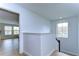 Bright second floor hallway with wood floors and views into adjacent rooms at 13118 Payton St, Odessa, FL 33556