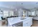 Kitchen featuring a central island, white cabinets, and a dining area perfect for gathering at 13118 Payton St, Odessa, FL 33556