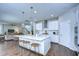 Bright kitchen with white cabinets, stainless steel appliances, and large island at 13118 Payton St, Odessa, FL 33556