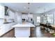 Bright kitchen featuring white cabinetry, stainless steel appliances, and a large center island with seating at 13118 Payton St, Odessa, FL 33556