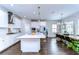 Bright kitchen with white cabinets, stainless steel appliances, and a large island with seating at 13118 Payton St, Odessa, FL 33556