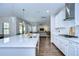 Bright open-concept kitchen with a center island, stainless steel appliances, and an adjacent living area at 13118 Payton St, Odessa, FL 33556