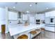 Bright kitchen showcasing a large island with bar seating, stainless appliances, and white cabinets at 13118 Payton St, Odessa, FL 33556