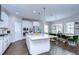 Bright kitchen with white cabinets, stainless steel appliances, island and eat-in area at 13118 Payton St, Odessa, FL 33556