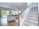 Bright living room features wood floors, a ceiling fan, and a staircase to the upper level at 13118 Payton St, Odessa, FL 33556