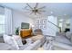 Large living room with hardwood floors, ceiling fan, TV and staircase at 13118 Payton St, Odessa, FL 33556