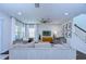 Bright living room with hardwood floors, ceiling fan, TV and staircase at 13118 Payton St, Odessa, FL 33556