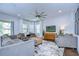 Spacious living room with a ceiling fan, comfortable seating, and view of the pool at 13118 Payton St, Odessa, FL 33556