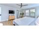 Serene main bedroom with a ceiling fan, natural light, TV, and stylish furnishings at 13118 Payton St, Odessa, FL 33556