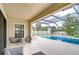 Inviting patio with lounge chairs offering seamless indoor-outdoor living with a screened-in pool view at 13118 Payton St, Odessa, FL 33556