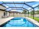 Beautiful pool with screened enclosure, featuring a modern design and ample space for lounging and relaxation at 13118 Payton St, Odessa, FL 33556