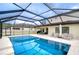 Inviting screened-in pool with surrounding patio space, ideal for enjoying sunny days and outdoor gatherings at 13118 Payton St, Odessa, FL 33556