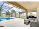 Relaxing pool patio with comfortable seating offering a perfect spot for lounging and enjoying outdoor living at 13118 Payton St, Odessa, FL 33556