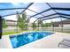 Sparkling screened-in pool surrounded by lush landscaping, offering a private oasis for relaxation and recreation at 13118 Payton St, Odessa, FL 33556