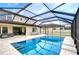 Stunning screened-in pool featuring crystal-clear water, perfect for refreshing swims and outdoor entertainment at 13118 Payton St, Odessa, FL 33556