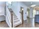 Elegant staircase with carpeted steps, wooden banister, and bright, open feel at 13118 Payton St, Odessa, FL 33556