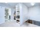 Bright walk-in closet showing extensive shelving with an open door leading to bathroom and desk space at 13118 Payton St, Odessa, FL 33556