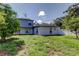 Spacious backyard with a lush lawn and mature trees, providing privacy and shade at 1402 Provincetown Cir, Lutz, FL 33549