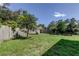 Backyard featuring a wooden fence with trees providing shade and privacy, great outdoor space at 1402 Provincetown Cir, Lutz, FL 33549