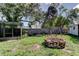 Large backyard featuring a brick fire pit, swing set, and screened-in porch, great for recreation at 1402 Provincetown Cir, Lutz, FL 33549