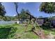 Fenced backyard with a wooden swing set and a brick fire pit, perfect for entertaining outdoors at 1402 Provincetown Cir, Lutz, FL 33549