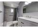 Updated bathroom featuring modern fixtures, a walk-in shower, and a marble vanity at 1402 Provincetown Cir, Lutz, FL 33549