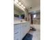Bathroom with single vanity, white cabinets and shower-tub combination at 1402 Provincetown Cir, Lutz, FL 33549